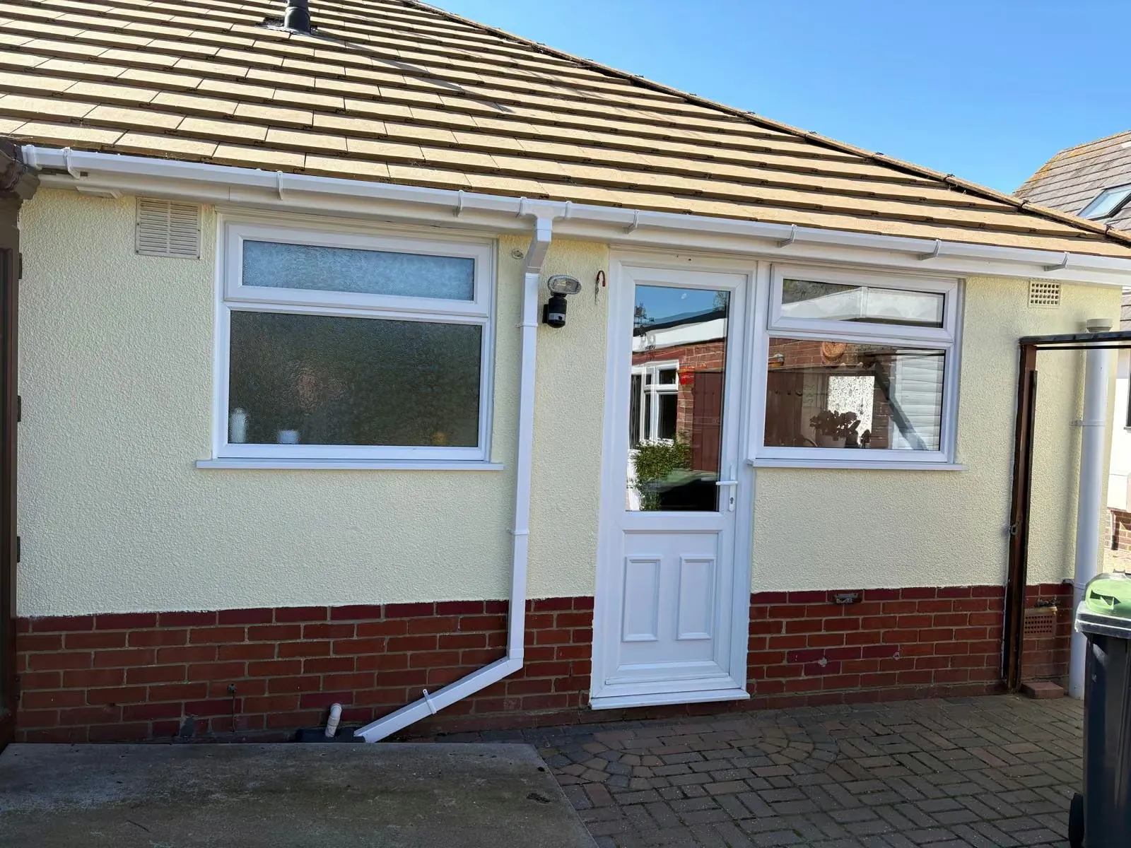 New white guttering and downpipe fitted to a bungalow