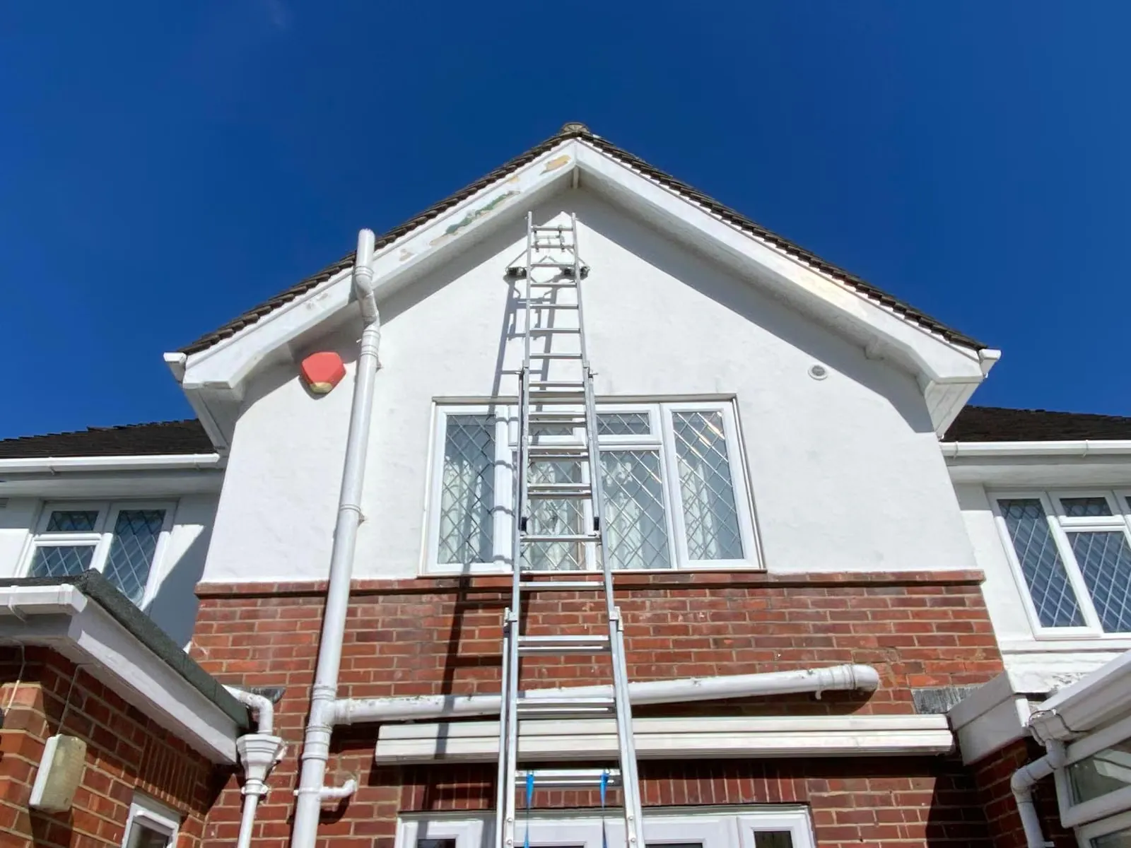 Fresh white fascia and guttering fitted around a local gable