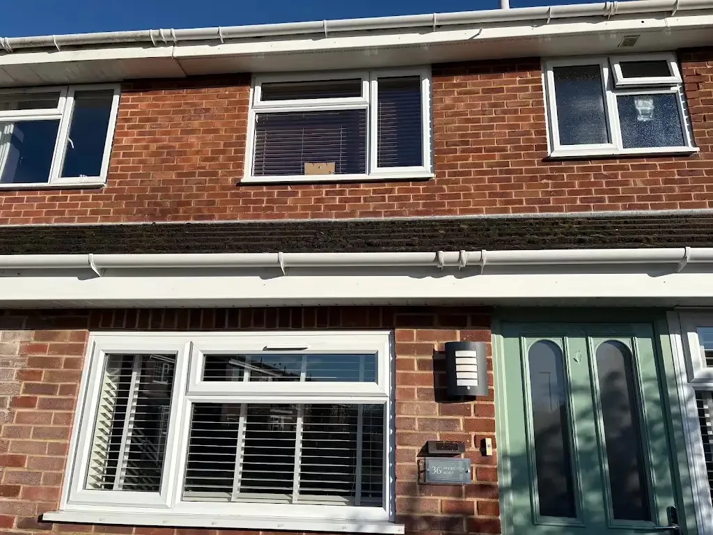 Completed white guttering and roofline work on a local home